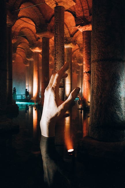 Mano che emerge dall'acqua nella Cisterna Basilica di Istanbul, evocando la grandezza dell'ingegneria romana e il potere imperiale.