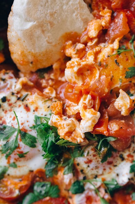Shakshuka con pane fresco e prezzemolo, ricetta per dosi precise con convertitore once grammi. Uova in salsa di pomodoro.
