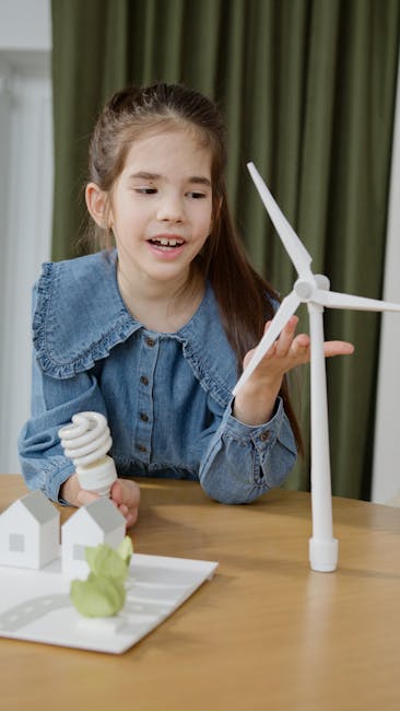 Bambina che studia energie rinnovabili con modellini eolico e lampadina a basso consumo, apprendimento a distanza efficace