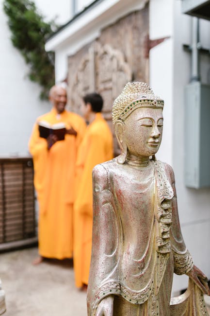 Statua di Buddha in primo piano con monaci sullo sfondo, simbolo di fede e spiritualità durante le Crociate