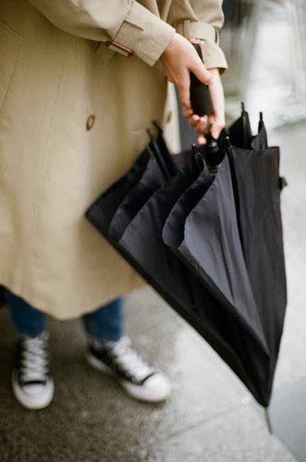 Persona apre ombrello nero, conversione libbre in kg per calcoli di peso e misure, guida pratica e approfondimenti utili.